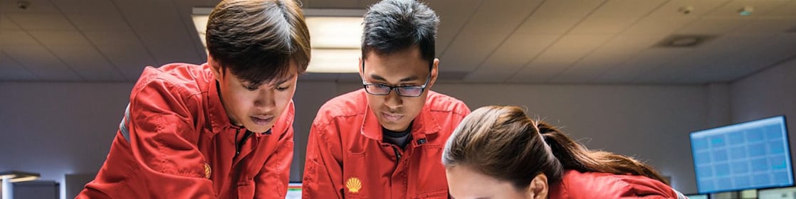 Three people looking at plans