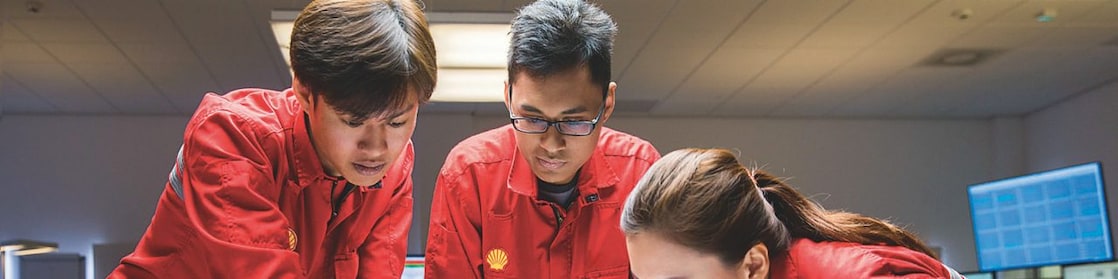Three people looking at plans